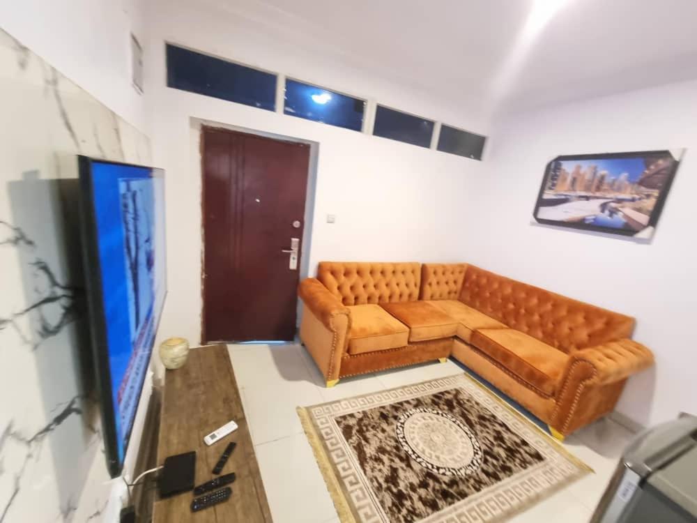 a living room with a couch and a tv at CBC Towers in Lagos