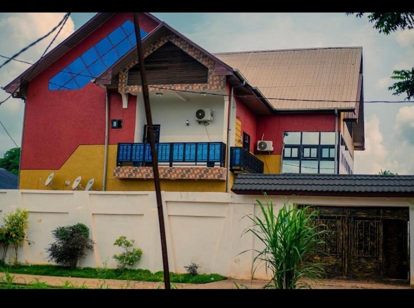 a house with a painting on the side of it at Auberge mfuma in Kisantu