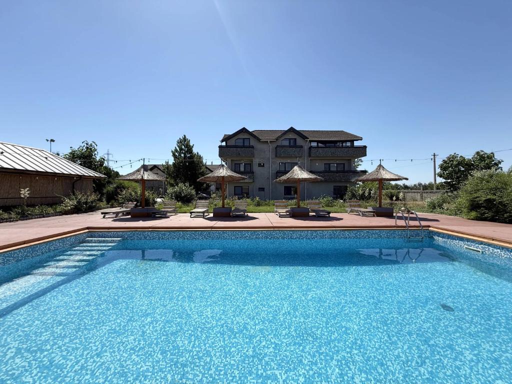 a large swimming pool in front of a building at Greenstone Land - Corbu in Năvodari