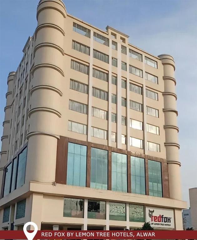 a tall building with a red toy row by lemon tree hotel at Red Fox by Lemon Tree Hotels, Alwar in Alwar