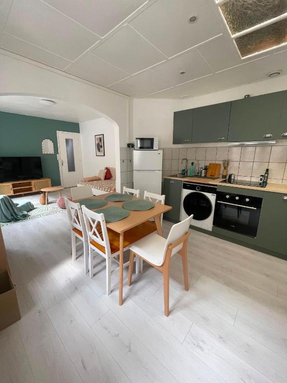 a kitchen and dining room with a table and chairs at Maison La Petite Pause in Bray-Dunes