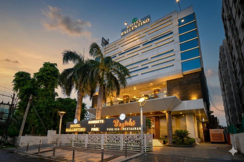 a hotel building with a sign in front of it at Hotel Rallentino in Kota