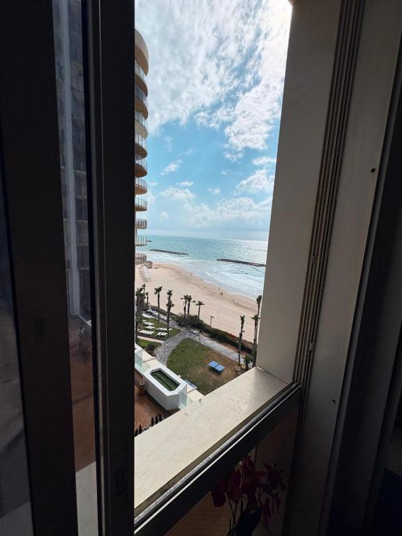 a view of the beach from a window at חדר לים הרצליה in Herzliya B