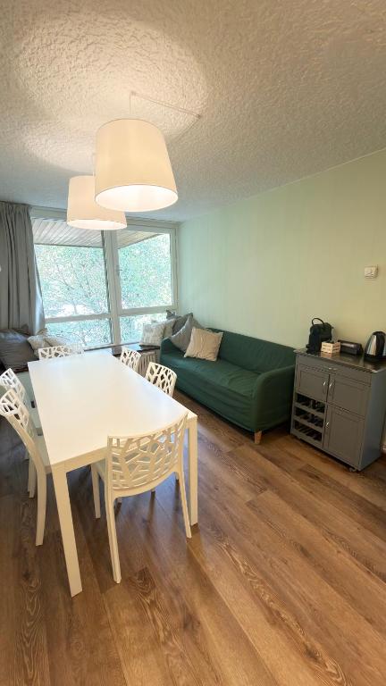 a living room with a table and a couch at LE VOLPI Marilleva 1400 in Marilleva