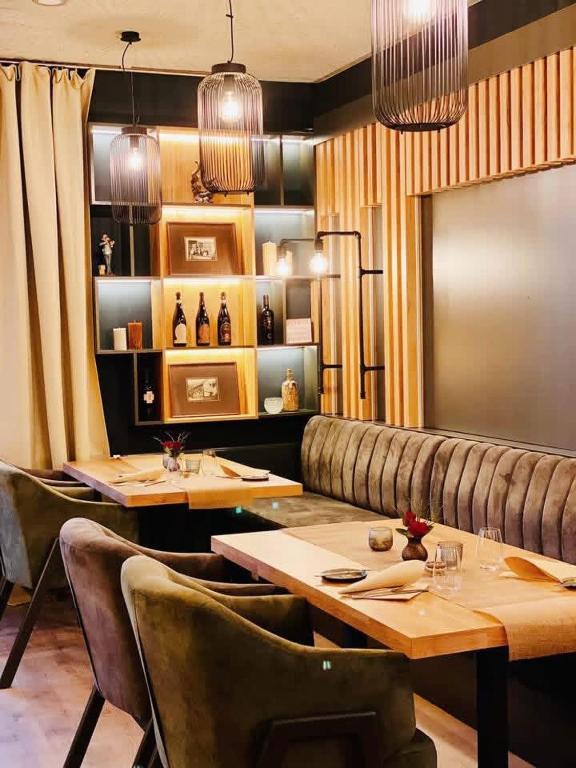 a restaurant with two tables and a leather couch at Wöllbacher Tor in Wetzlar