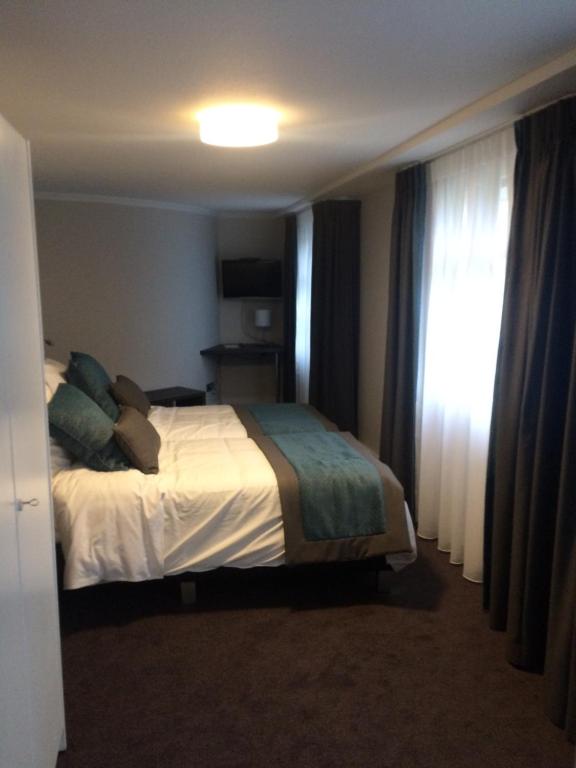 Postel nebo postele na pokoji v ubytování Hotel Du Moulin