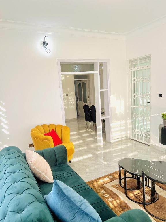a living room with a couch and a table at His Goodness - Apt Two! in Kampala