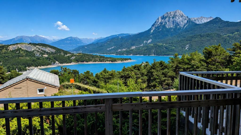 a view of a lake from a balcony at Résidence Serre-Ponçon in Chorges