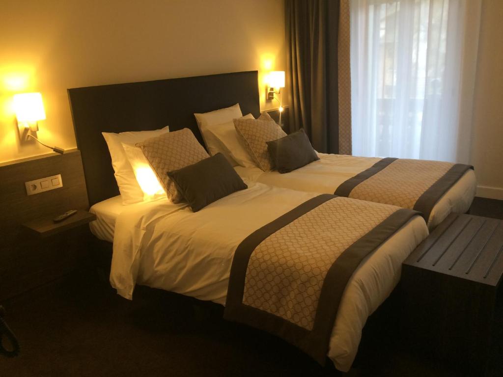 Postel nebo postele na pokoji v ubytování Hotel Du Moulin