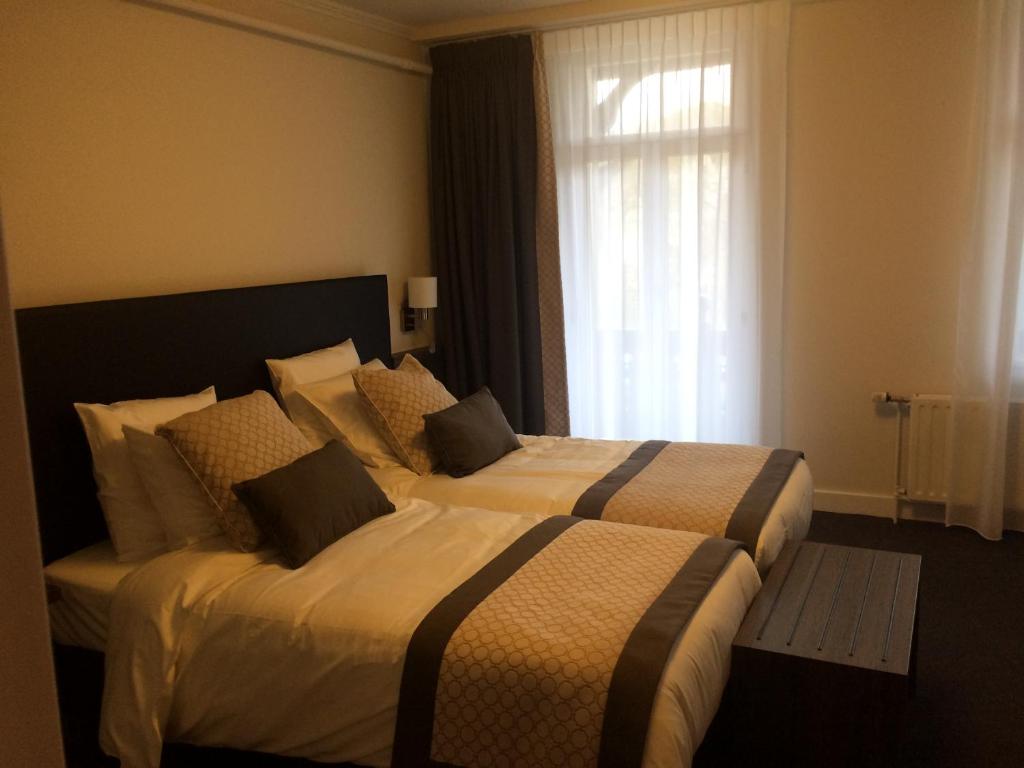 Postel nebo postele na pokoji v ubytování Hotel Du Moulin