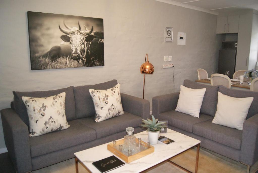 a living room with a couch and a table at Chalet Eland in Ladismith