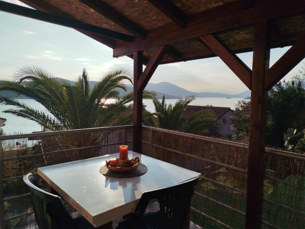 a table with a candle on top of a balcony at Apartment Jankovic in Tivat