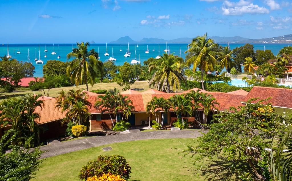 an aerial view of a resort with boats in the water at Studio confortable à Sainte-Anne - 30 m² avec vue mer in Sainte-Anne