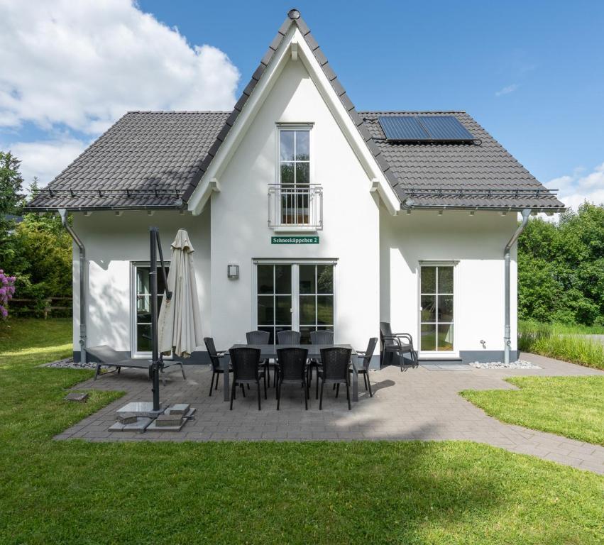 a white house with solar panels on the roof at Schneekäppchen 2 in Winterberg