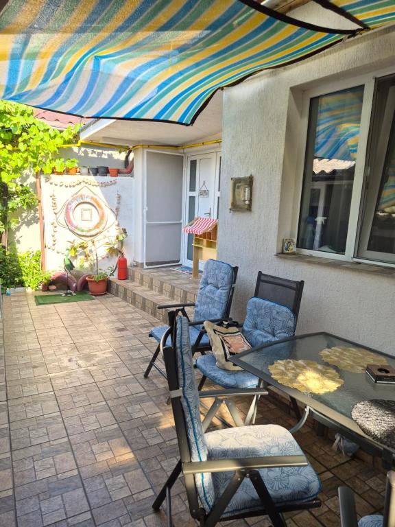 a patio with a table and chairs on a patio at Casa AVA 2 Mai in 2 Mai