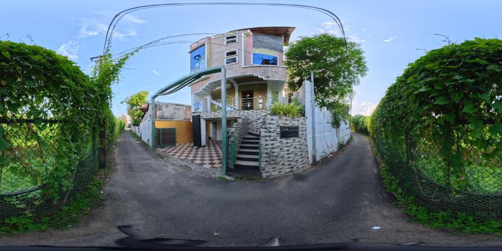 a house in the middle of a street at J V A Home stay Apartment Hotel in Kollam