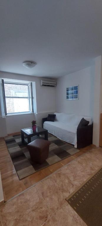 a bedroom with a large bed and a table at Medin BD in Budva