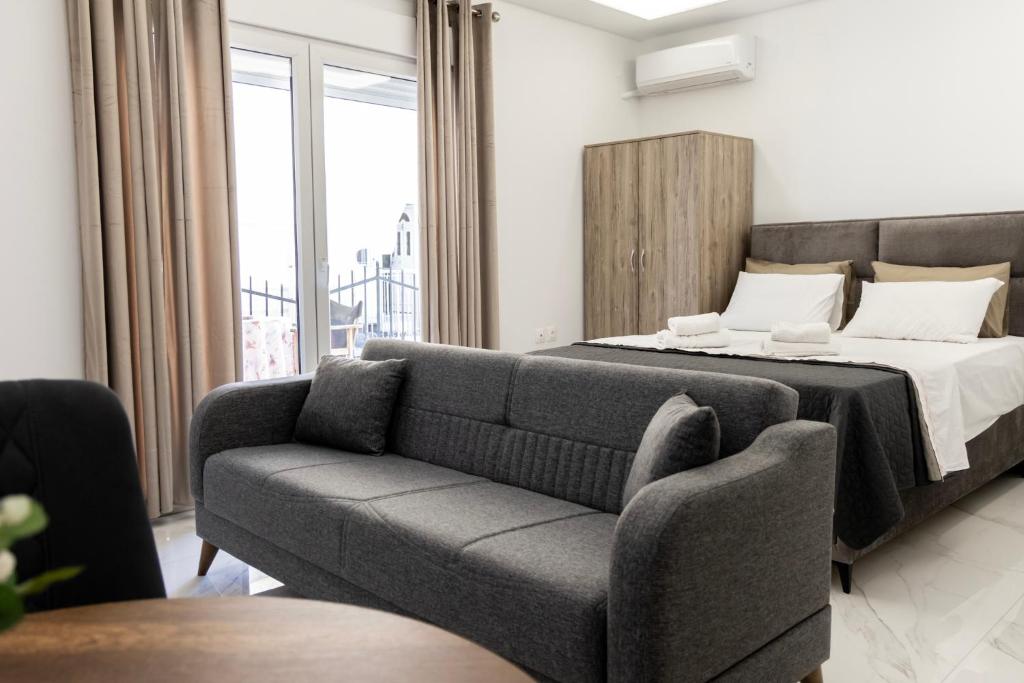 a living room with a bed and a couch at Beautiful Apartment in Larisa