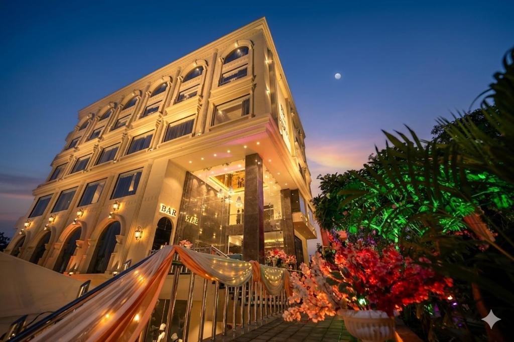a large building with lights in front of it at Hotel The Sawai in Jaipur