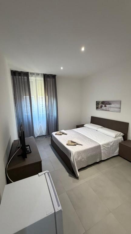 a bedroom with a large bed and a table at Le Case di Stela in Terni
