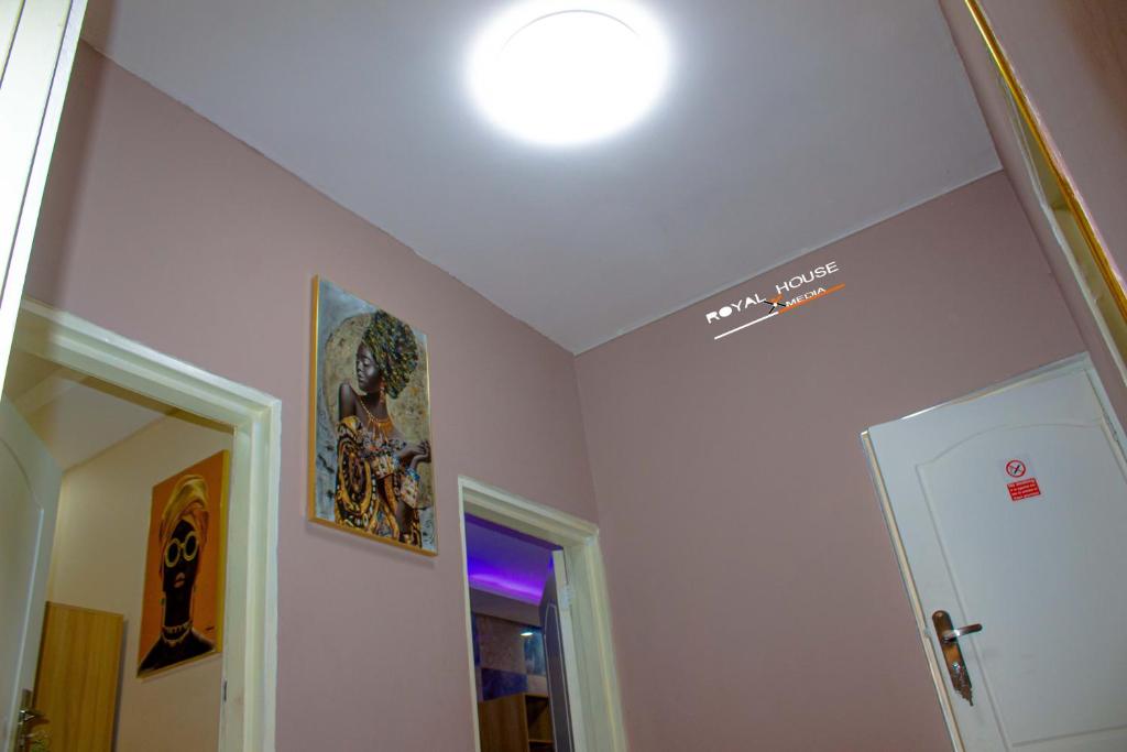 a room with a ceiling with a sign on the wall at 7Palms Executive Lodges in Ndola