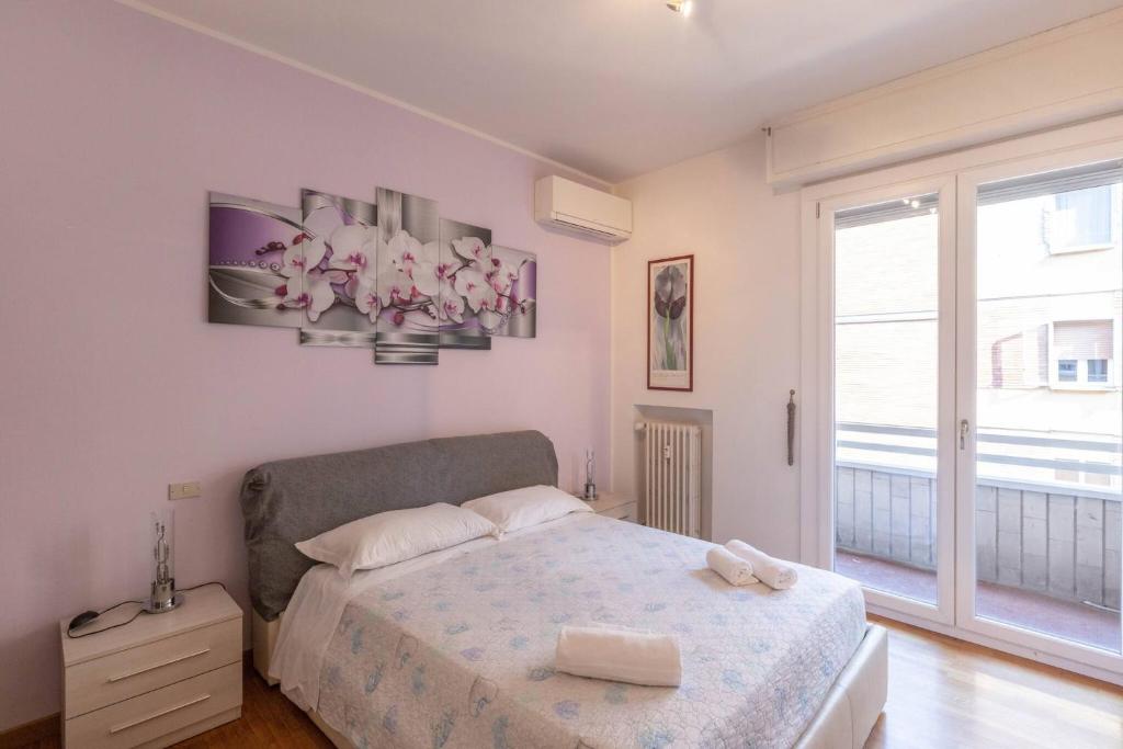 a bedroom with a bed and a large window at Borgo House, Bologna by Short Holidays in Bologna