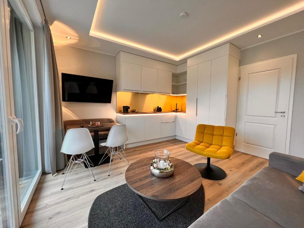 a living room with a couch and a table at Hotel LandGut & Residenz DRIEHOF in Tecklenburg