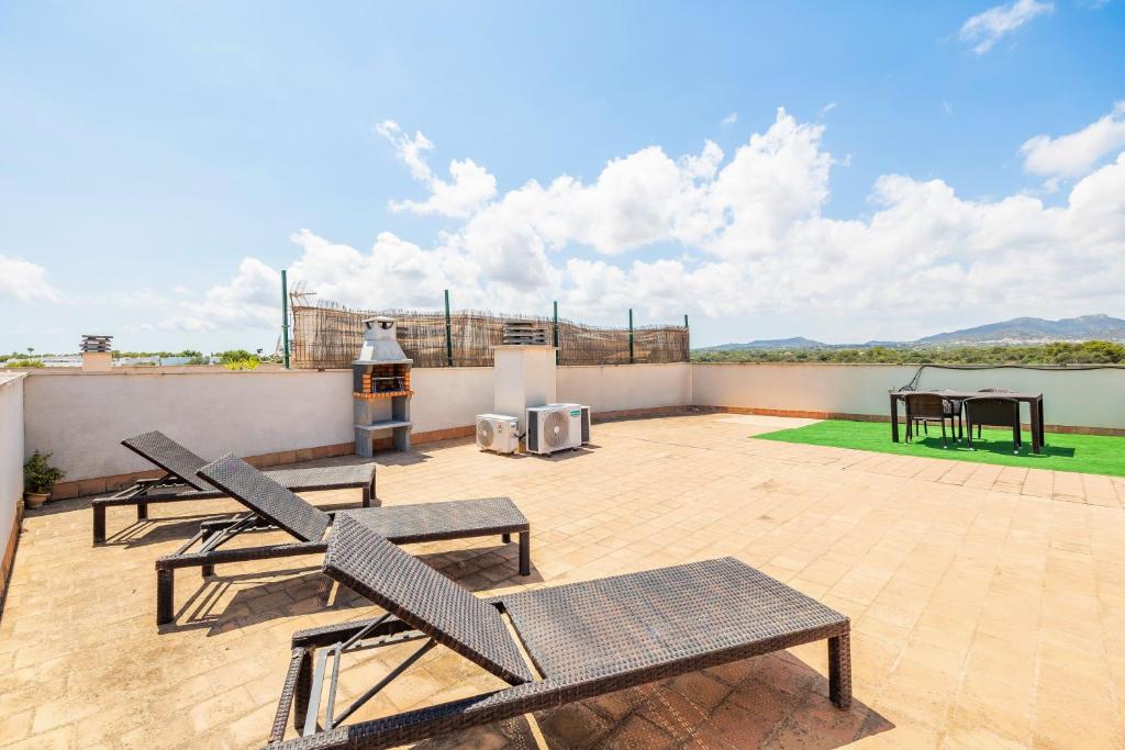 a patio with two chairs and a table on a roof at Ferrera Soul 2a in Felanitx