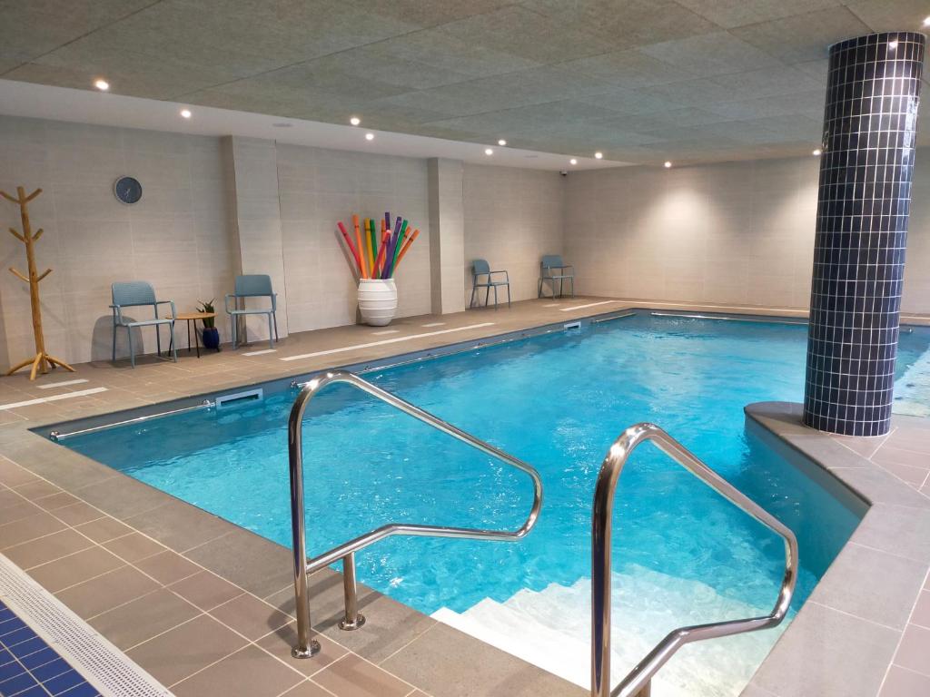 a large swimming pool in a hotel room at DOMITYS - Les Quernons in Trélazé