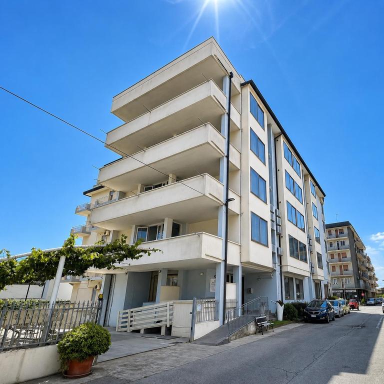 a white apartment building on the side of a street at Residenza Sant'Antonio - Sottomarina in Sottomarina