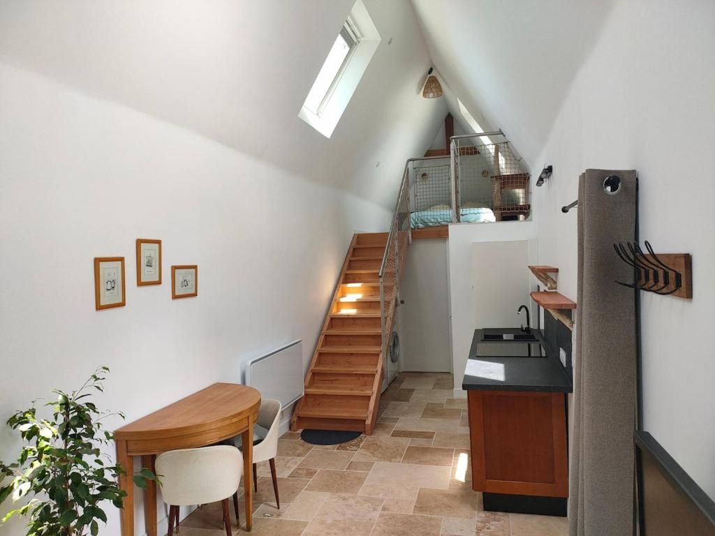 a staircase in a room with a table and a desk at Authentic Breton penty in Penmarch