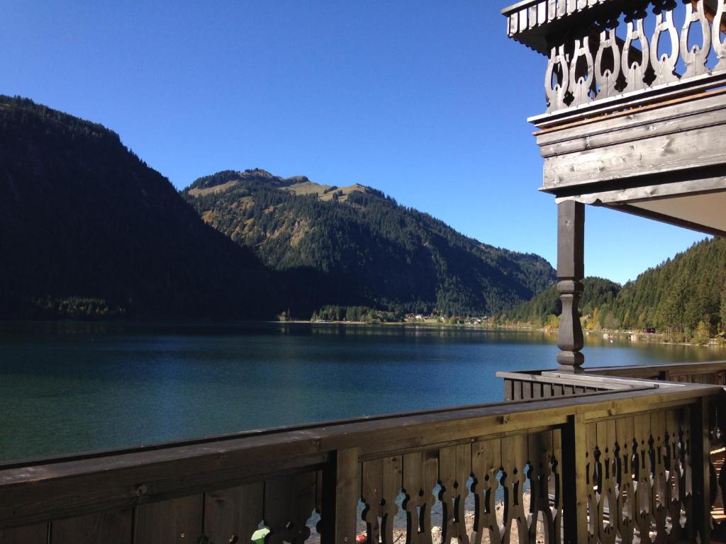 a view of a lake from a balcony of a house at Das Haldensee in Nesselwängle