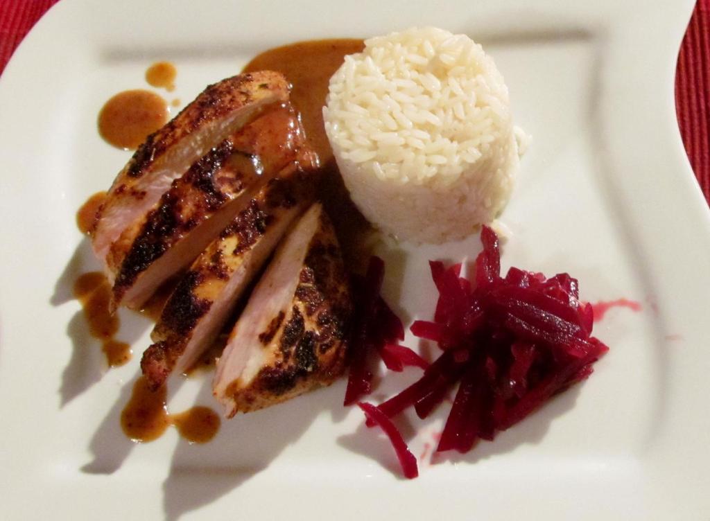 a plate of food with rice and meat at Landgasthof Hegau in Dunaszekcső