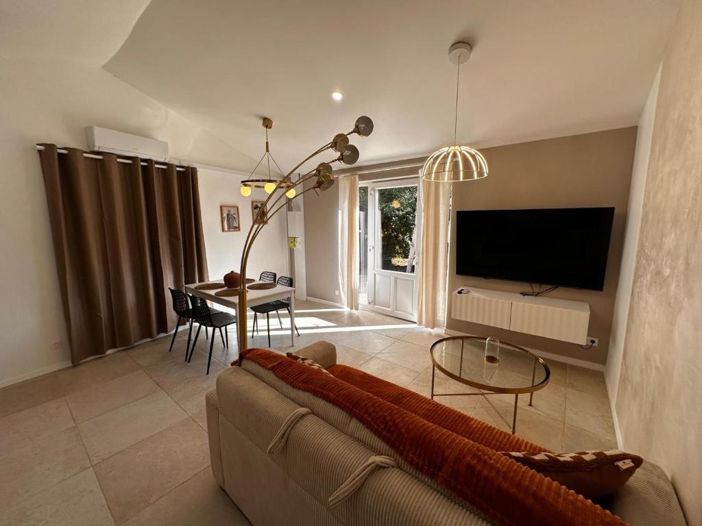 a living room with a couch and a table at White housse - cabane - Sèvre Niortaise in Niort