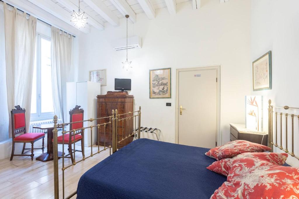 a bedroom with a bed and a table and chairs at Nel Cuore di Bologna M ,Bologna by Shortholidays in Bologna