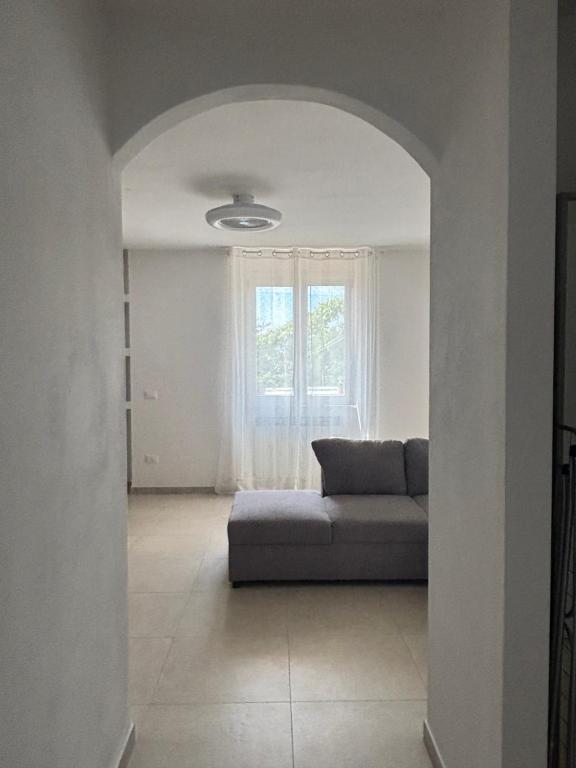 a living room with a couch and a window at Oasi Lake Iseo in Solto Collina
