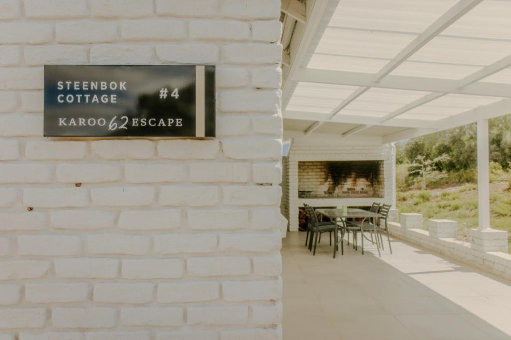a sign on the side of a building with a fireplace at Chalet Steenbok in Ladismith