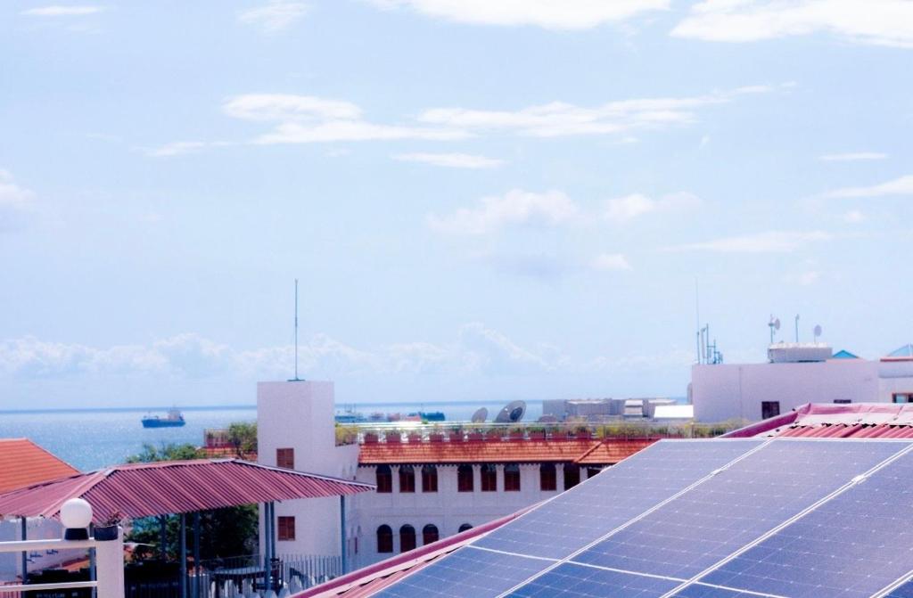 a group of solar panels on the roof of a building at NorArt House in Zanzibar City