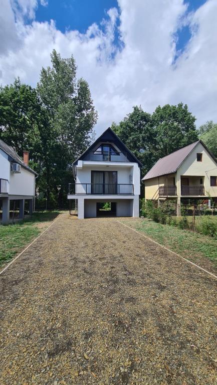 a white house with a black roof at Officium P49 in Rakamaz