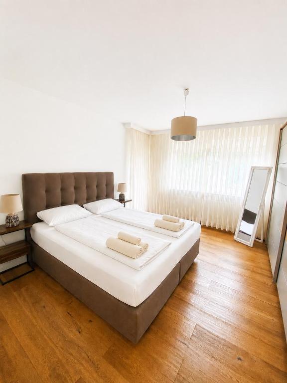 a bedroom with a large bed with two towels on it at Nürnberg Central Flat in Nuremberg