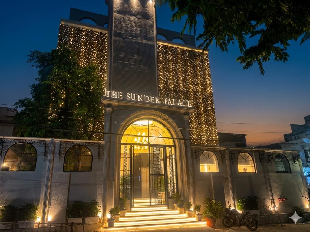 a building with a sign that reads the sunset palace at The Sunder Palace-Jaipur City Centre Hotel in Jaipur