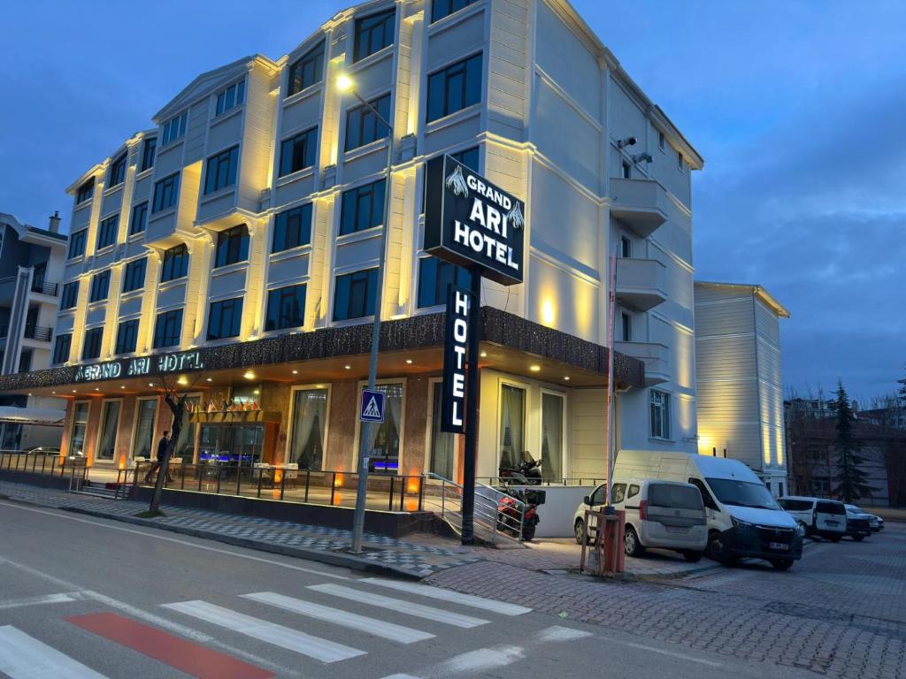 a large building with a street sign in front of it at Afyon Grand Arı Hotel in Afyon