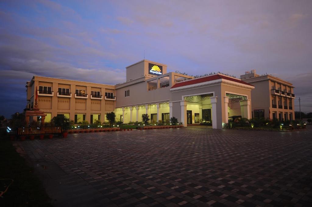 a large building with a clock tower on top of it at Surya Garden in Tālcher