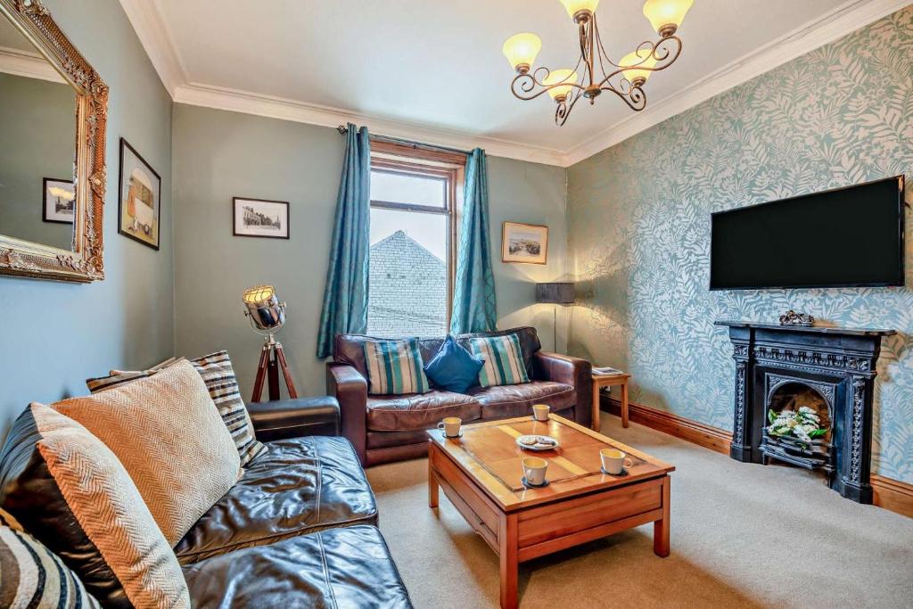 a living room with a couch and a fireplace at 5 Bed in Tynemouth oc-cn125 in Tynemouth