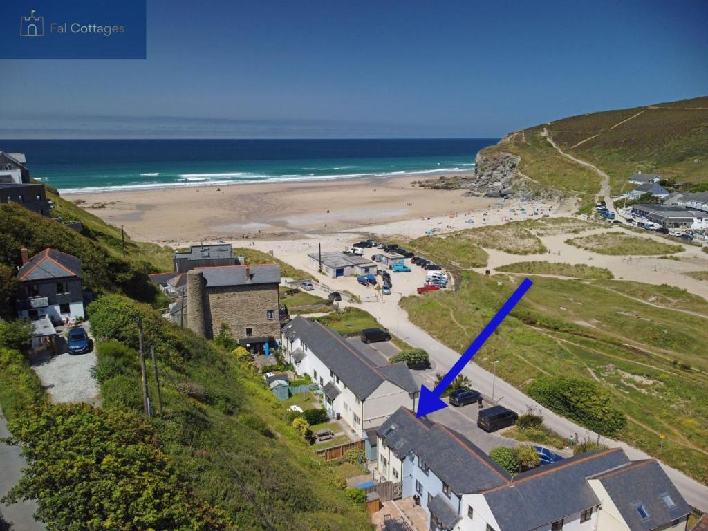 an aerial view of a beach with a blue arrow at Driftwood in Porthtowan
