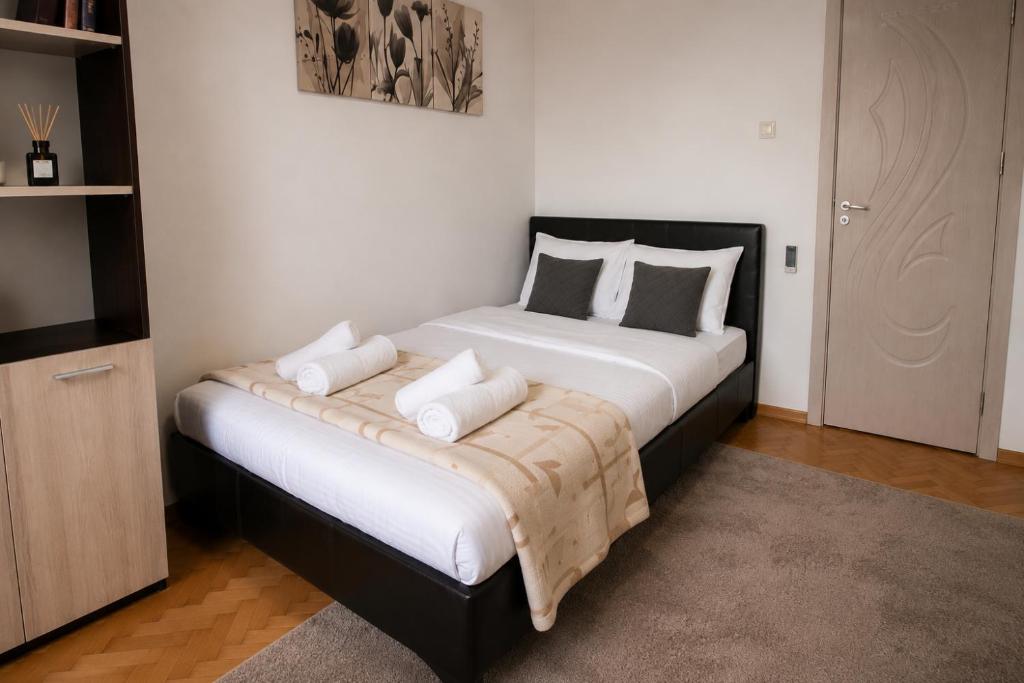a bedroom with a large bed with white sheets and pillows at City Centre Room Near Everything in Varna City
