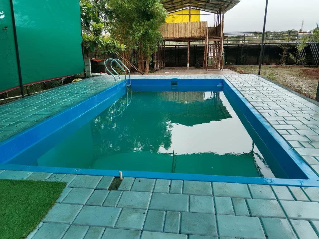 a swimming pool in a house with a blue swimming pool at White House KMCT in Kapūrwāhāl