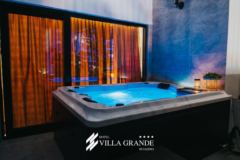 a large tub in a bathroom with a shower at Villa Grande Terrace Jacuzzi Suite in Bugojno