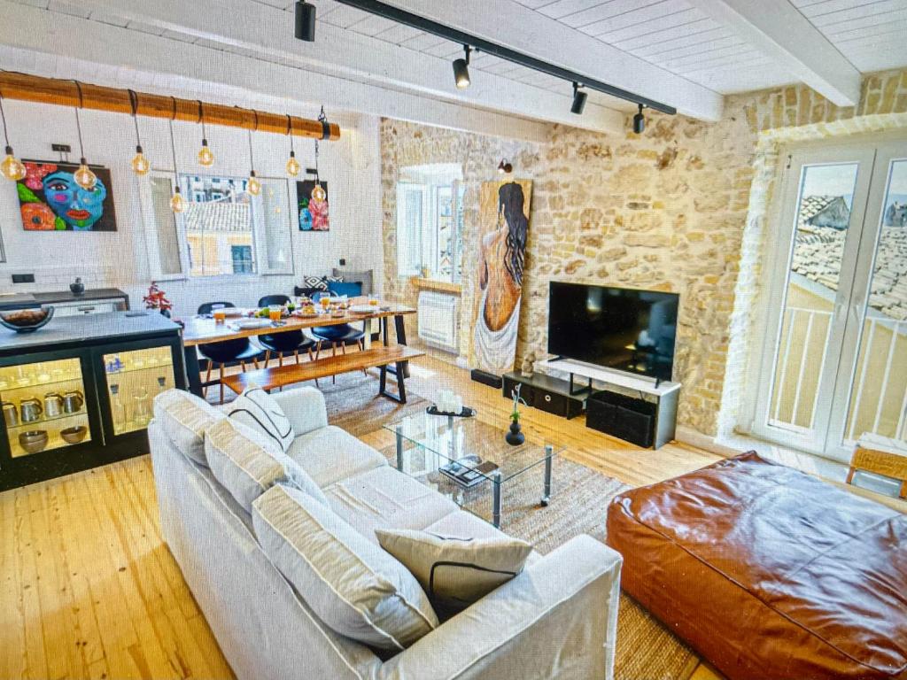 a living room with a couch and a table and a television at Amazing apartment with view in Kanoni