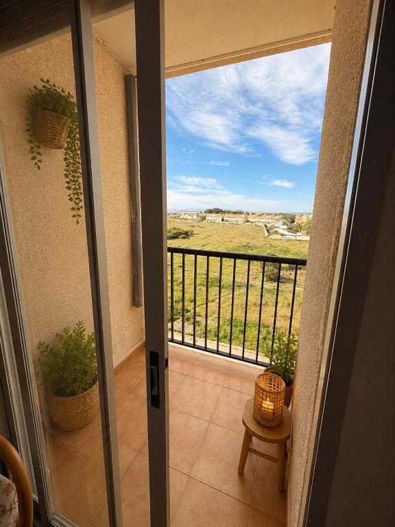 a door to a balcony with a view of a field at Mabre view in La Mata
